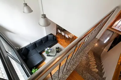 an overhead view of a living room with a black couch at My Space Barcelona Park Güell Apartments in Barcelona