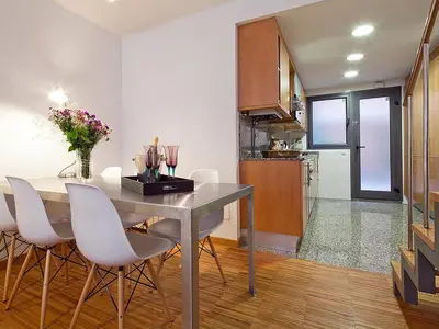 a kitchen and dining room with a table and chairs at My Space Barcelona Park Güell Apartments in Barcelona