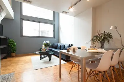 a living room with a table and a couch at My Space Barcelona Park Güell Apartments in Barcelona