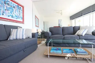 a bed in a room with a picture of a dog at Apartment Alegria (Happy) in Sitges