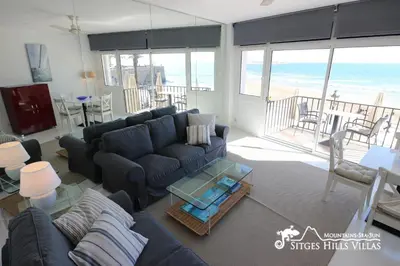 a table on a balcony with a view of the beach at Apartment Alegria (Happy) in Sitges