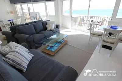 a living room with a couch and a view of the ocean at Apartment Alegria (Happy) in Sitges