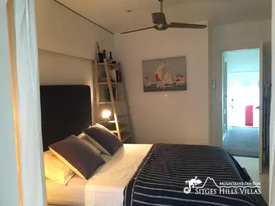 a bedroom with a bed and a ceiling fan at Apartment Alegria (Happy) in Sitges