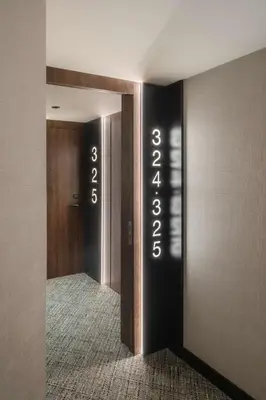 a hallway with a door with numbers on the wall at Radisson Blu 1882 Hotel, Barcelona Sagrada Familia in Barcelona