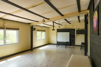 an empty room with a whiteboard in the middle at Masía Cal Simó - Casa rural con piscina, cerca de Sitges, para celebraciones y eventos in Canyelles