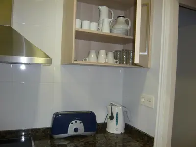 a bedroom with a bed and a dresser and a mirror at Apartament Conde Güell in Barcelona