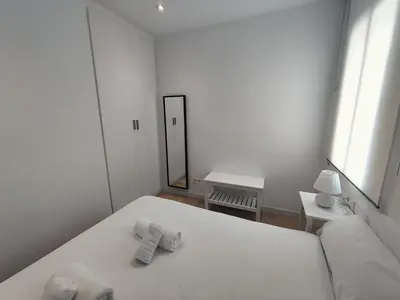 a kitchen with a counter with a toaster and cups at Apartament Conde Güell in Barcelona