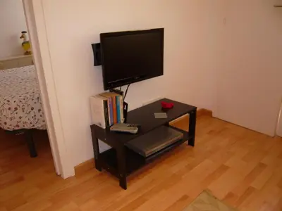 a living room with a white couch and a red cabinet at Apartament Conde Güell in Barcelona