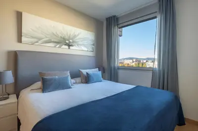 a bedroom with a large bed with a large window at Rent Top Apartments Forum in Sant Adria de Besos