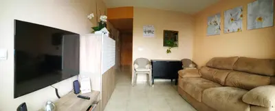 a living room with a couch and a flat screen tv at White Stones Beach In Sant Pol de Mar in San Pol de Mar