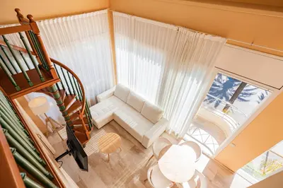 a living room with a white couch and a window at MAREA Hotel in Vilanova i la Geltrú