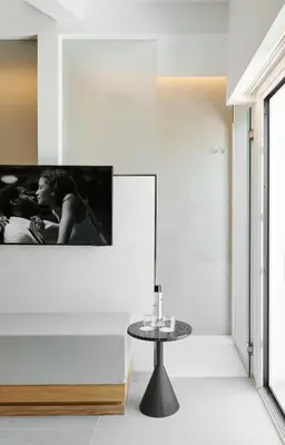 a living room with a table and a tv on the wall at Hotel restaurant Ceferino in Vilanova i la Geltrú