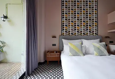 a bedroom with a large bed with a large headboard at Numa Barcelona Roca in Barcelona