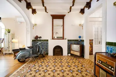 a scooter parked in a living room with a fireplace at Numa Barcelona Roca in Barcelona