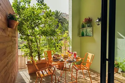 a dining room with a table and chairs on a patio at Numa Barcelona Roca in Barcelona