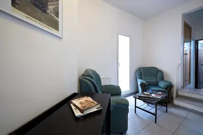 a living room with two chairs and a table at Hostal Elkano in Barcelona