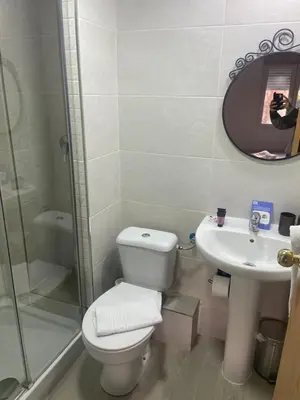 a bathroom with a toilet and a sink and a mirror at Hostal Elkano in Barcelona