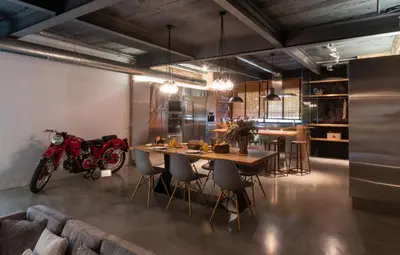 a room with a table and a motorcycle in it at Petit Luxe Loft in Terrassa