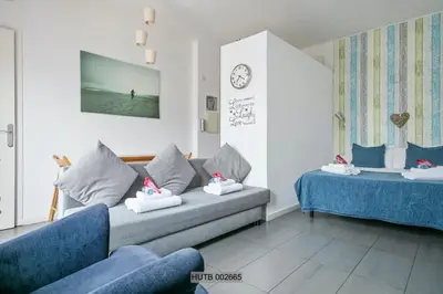 a living room with a couch and a bed at Alcam Pau Claris in Barcelona