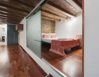 a room with a bed and a glass wall at Stay U-nique Apartments Plaça Universitat in Barcelona