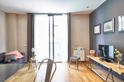 a living room with a couch and a tv at AinB Sagrada Familia Apartments in Barcelona
