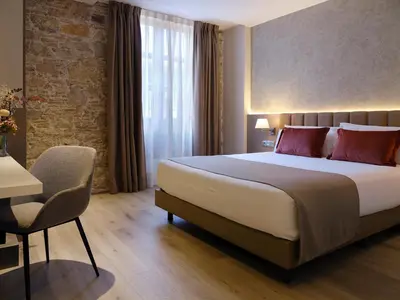 a hotel room with a bed and a table and a chair at Musik Boutique Hotel - Solo Adultos in Barcelona