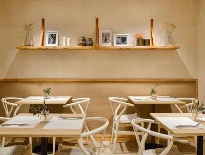 a dining room with tables and chairs and shelves at Musik Boutique Hotel - Solo Adultos in Barcelona