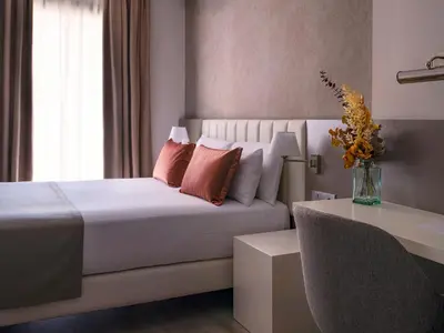 a bedroom with a bed and a vase of flowers at Musik Boutique Hotel - Solo Adultos in Barcelona