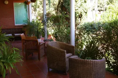 a patio with wicker chairs and a table at B&B Inés in Sant Cugat del Vallès