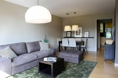 a living room with a couch and a table at PASSEIG DE GRACIA SUN APARTAMENT BALCONY / 2 BEDROOMS in Barcelona