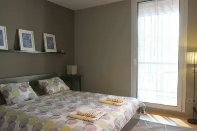 a bedroom with a bed with two pillows on it at PASSEIG DE GRACIA SUN APARTAMENT BALCONY / 2 BEDROOMS in Barcelona