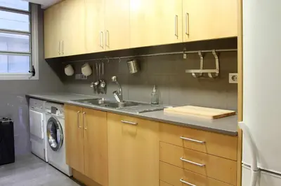 a kitchen with a sink and a washing machine at PASSEIG DE GRACIA SUN APARTAMENT BALCONY / 2 BEDROOMS in Barcelona