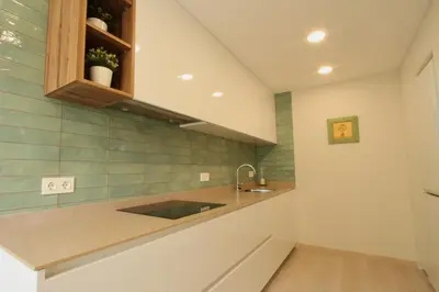 a kitchen with a sink and a counter at Beach House Castelldefels in Castelldefels
