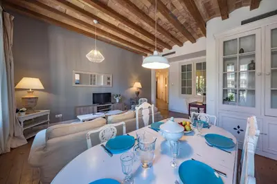 a dining room with a white table and chairs at Habitat Apartments Alaia in Barcelona