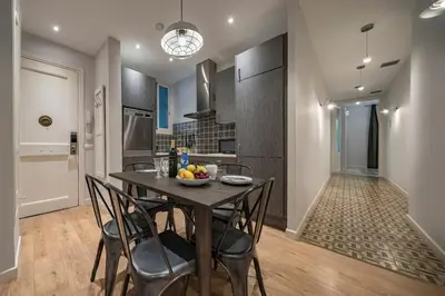 a kitchen and dining room with a table and chairs at Habitat Apartments Alaia in Barcelona