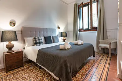 a bedroom with a large bed with two teddy bears on it at Habitat Apartments Grace in Barcelona