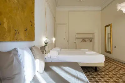 a bedroom with two beds and a painting on the wall at SibsBcn- Rambla- Family Friends Business Central in Barcelona