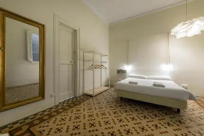 a bedroom with a bed and a large mirror at SibsBcn- Rambla- Family Friends Business Central in Barcelona