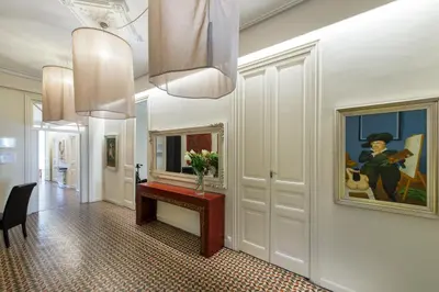 a hallway with a table and a painting on the wall at SibsBcn- Rambla- Family Friends Business Central in Barcelona