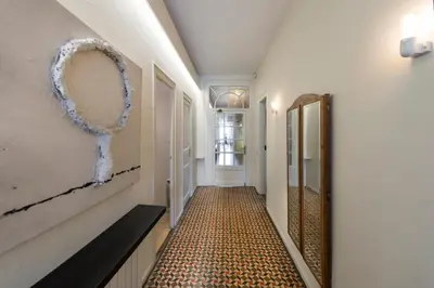a hallway with a tile floor and a mirror at SibsBcn- Rambla- Family Friends Business Central in Barcelona