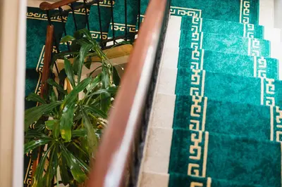 a stairway with a green and white stair runner at Hotel Torre Barcelona in Sant Cugat del Vallès