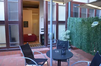a patio with a table and chairs in a building at Hotel Center Gran Via in Barcelona