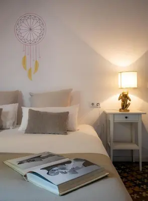 a hotel room with a book on the bed at Primavera Hostel in Barcelona