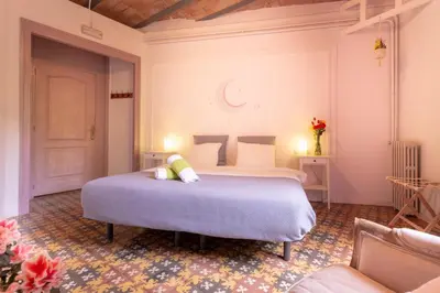 a bedroom with two beds and a couch at Primavera Hostel in Barcelona