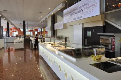 a woman standing in front of a counter in a restaurant at Apartamentos Montserrat Abat Marcet in Montserrat
