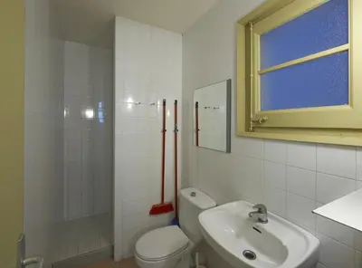 a white bathroom with a toilet and a sink at Apartamentos Montserrat Abat Marcet in Montserrat
