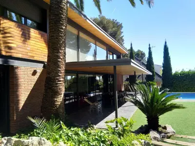 an external view of a house with a tree at VILLA DEL BOSQUE in Castelldefels