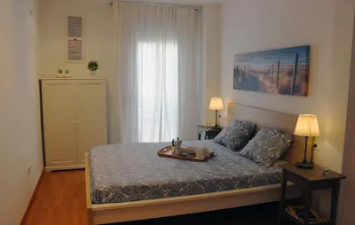 a bedroom with a bed with a tray on it at Sitges Ático 2 min a Playa San Sebastían in Sitges