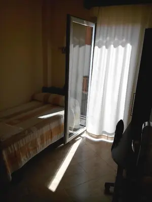 a bedroom with a bed and a window with a mirror at Hostal Sant Sadurní in Sant Sadurní dʼAnoia