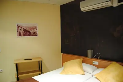 a bedroom with a bed and a painting on the wall at Guilleumes Montserrat in Monistrol